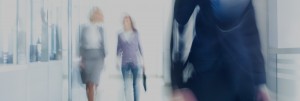blurred image of women walking in office