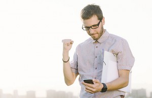 man celebrating with phone in hand