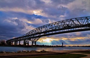 Beams of light illuminate the Canadian shore with the Blue Water Bridge in the foreground