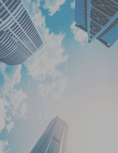 looking up at skyscrapers and a cloudy sky