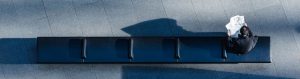 aerial view of long bench with person reading newspaper at the end