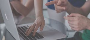 people pointing at a computer