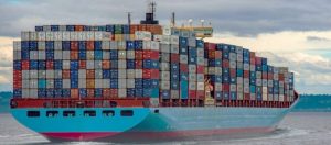 Blue shipping container loaded with containers at sea